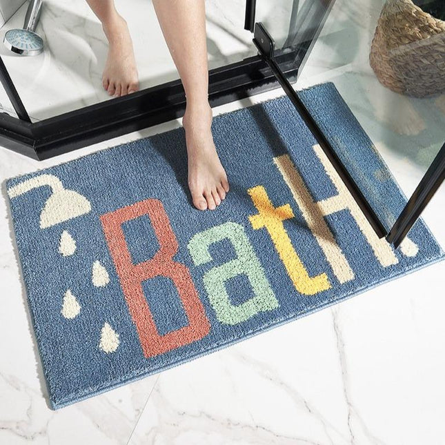 Kongeblå badematte med "Bath" tekst