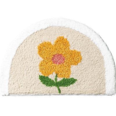 Halvrund badematte med gul blomst